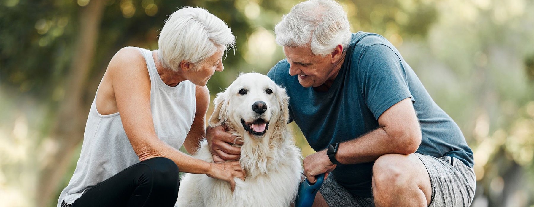 a man and woman petting a dog