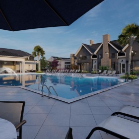 Relax and unwind poolside a pool with a deck and chairs