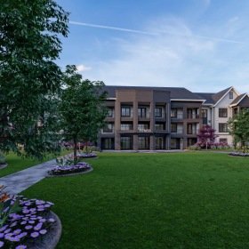 Settle into comfort at The Canter a large green lawn with trees and buildings in the background